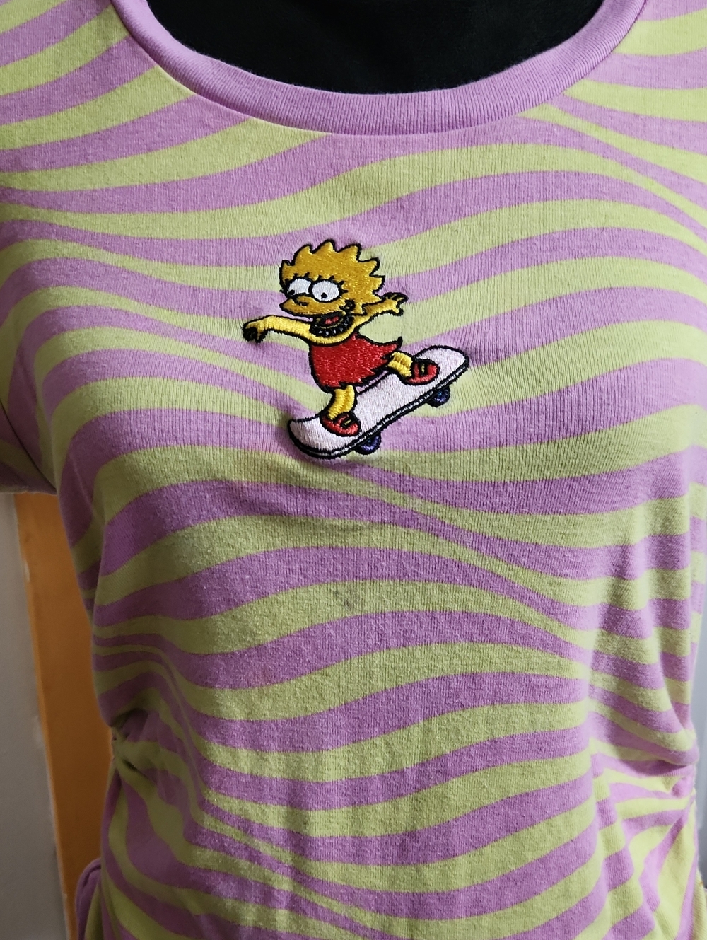 Lisa Simpson Skateboarding pink and yellow ruched tee.